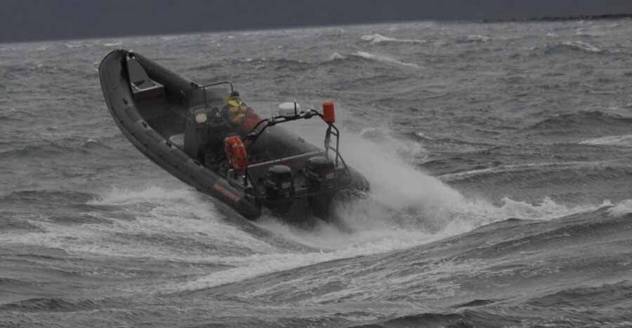 A boat is floating on top of a large body of water.
