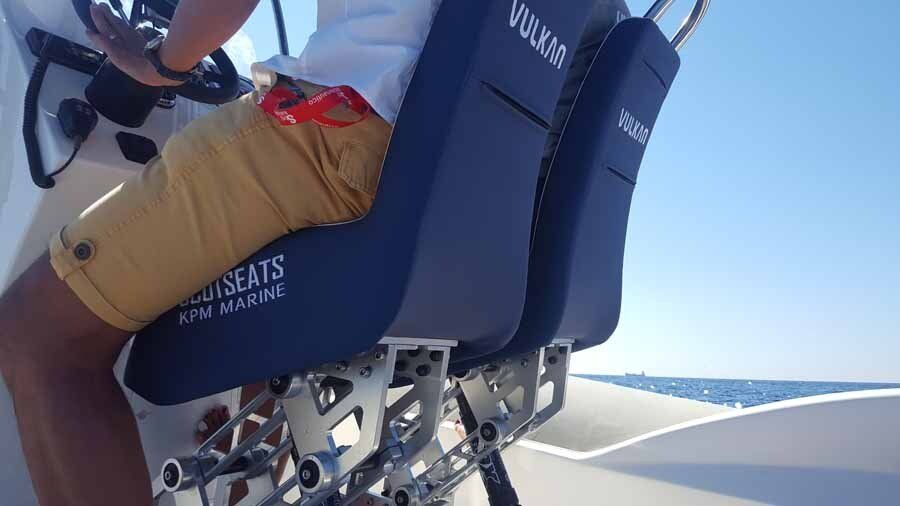 A man is sitting in a chair on a boat.
