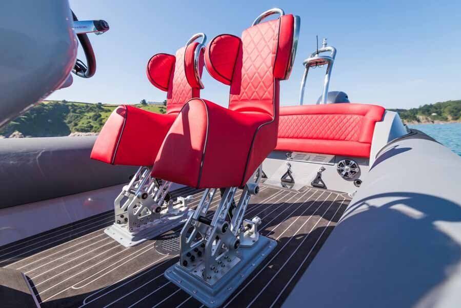 A boat with red seats on it is floating on top of a body of water.
