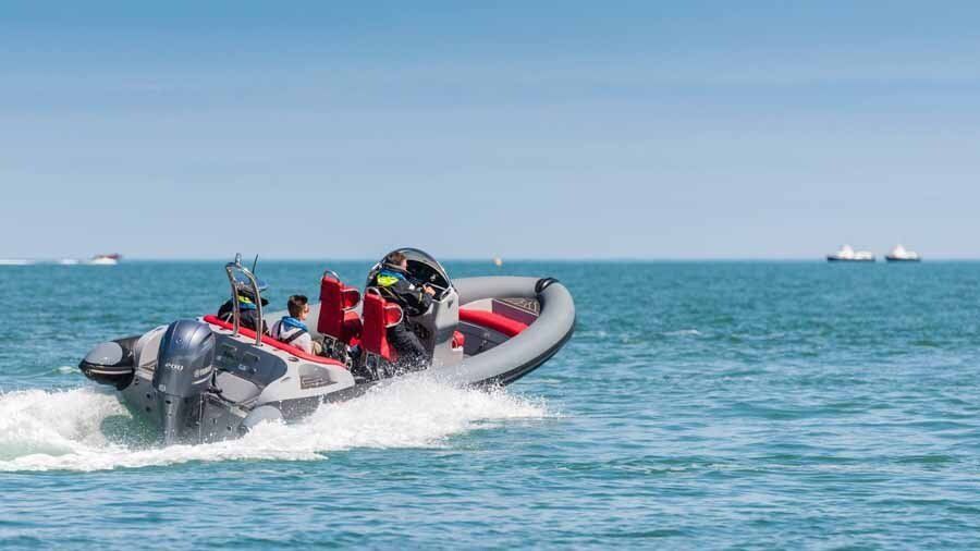 A boat is floating on top of a body of water.