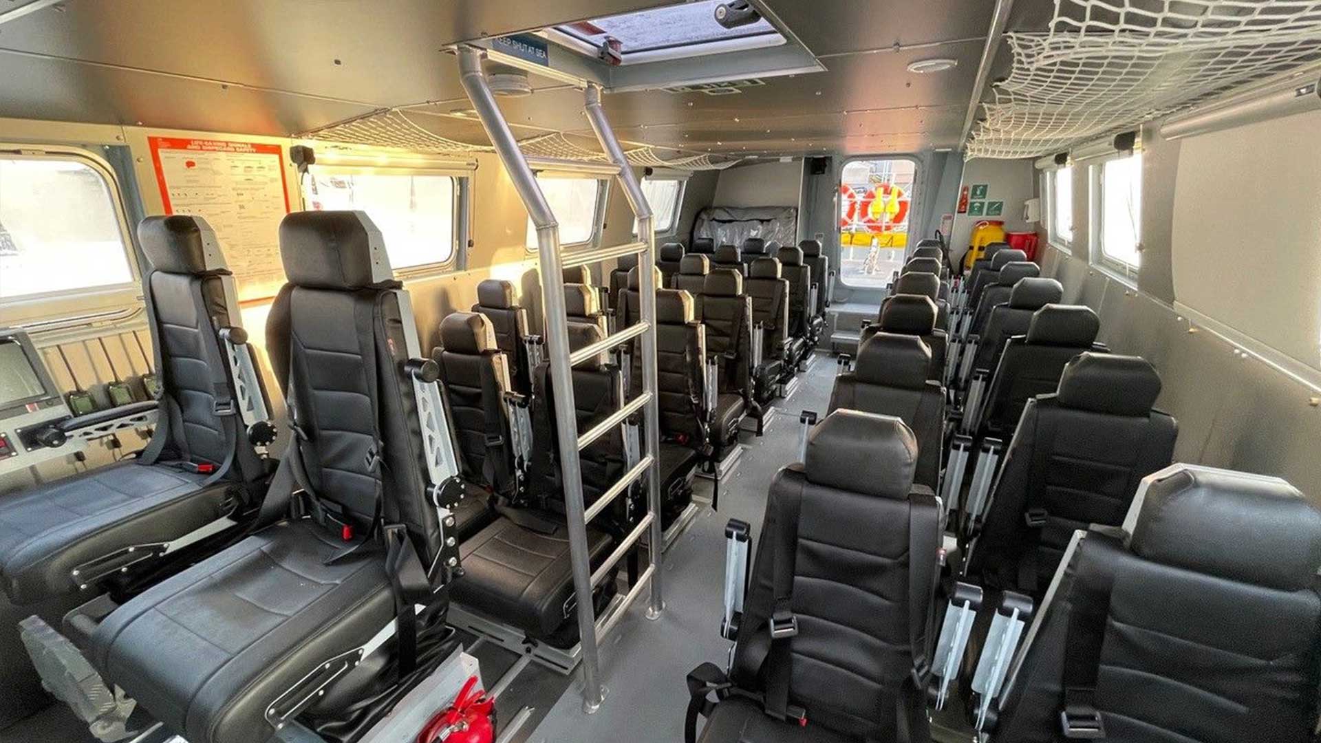 The inside of naval training boat a lot of seats