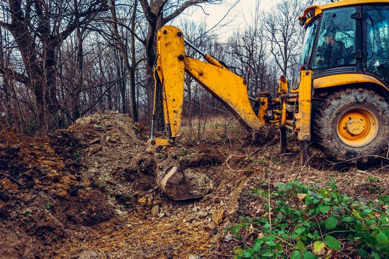 A Yellow Excavator Clearing Dig Soil - Aberdeen, MS - Ground Pounders