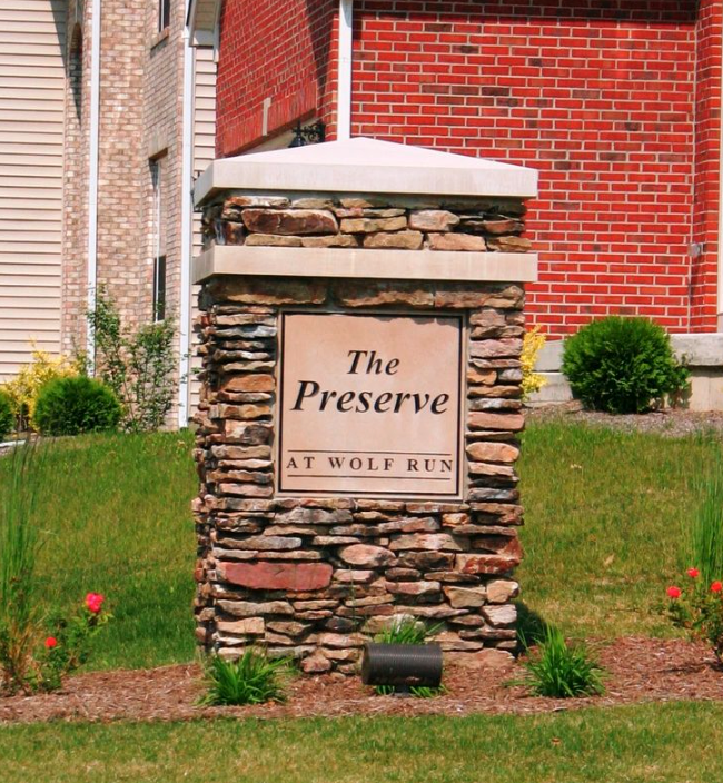 neighborhood sign with masonry base