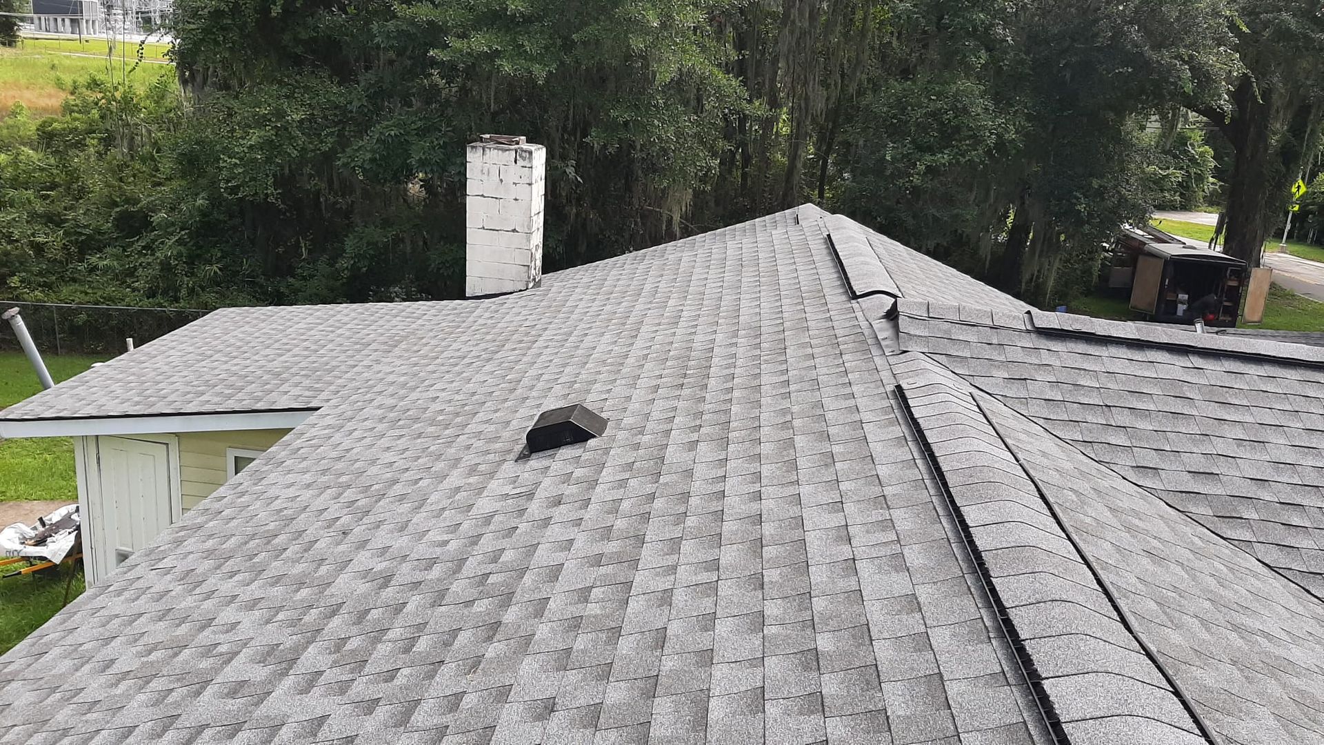 Man is Working on the Roof of a House — Savannah, GA — 1 Construction Kings LLC