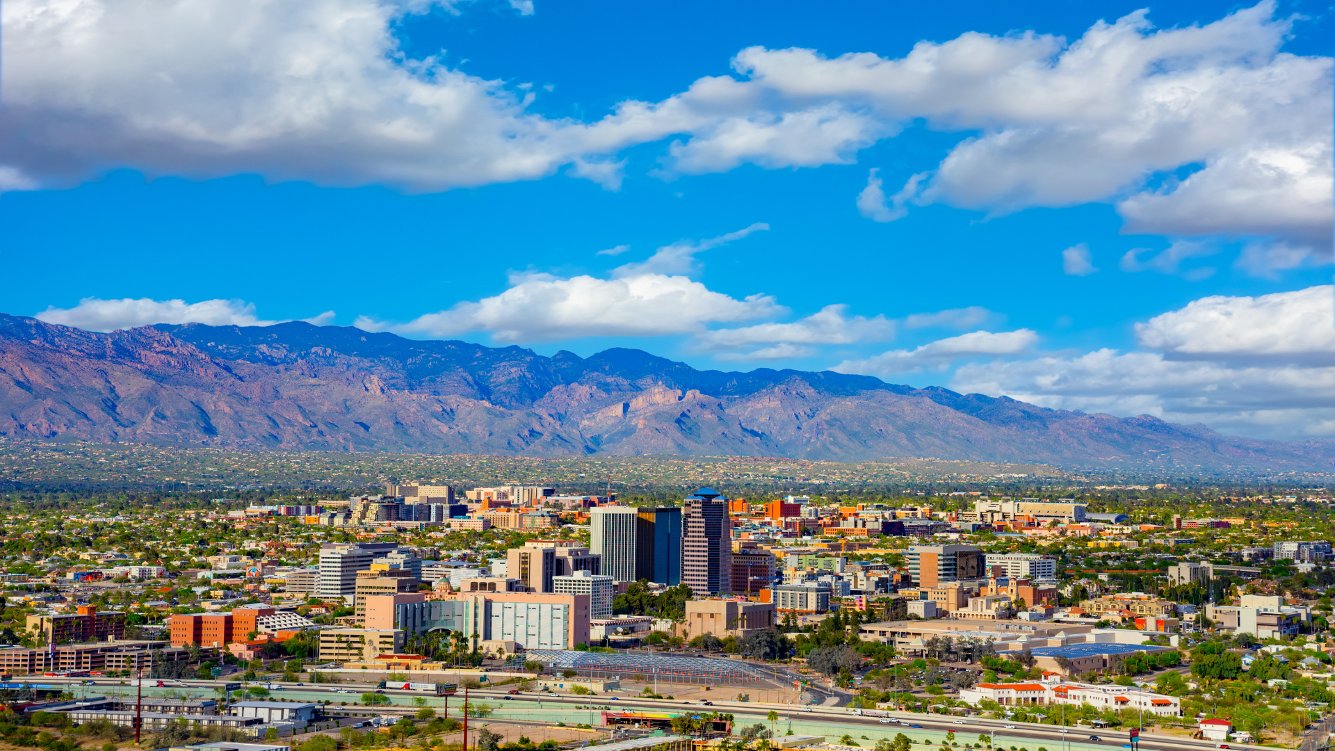 An aerial view of a city with mountains in the background.