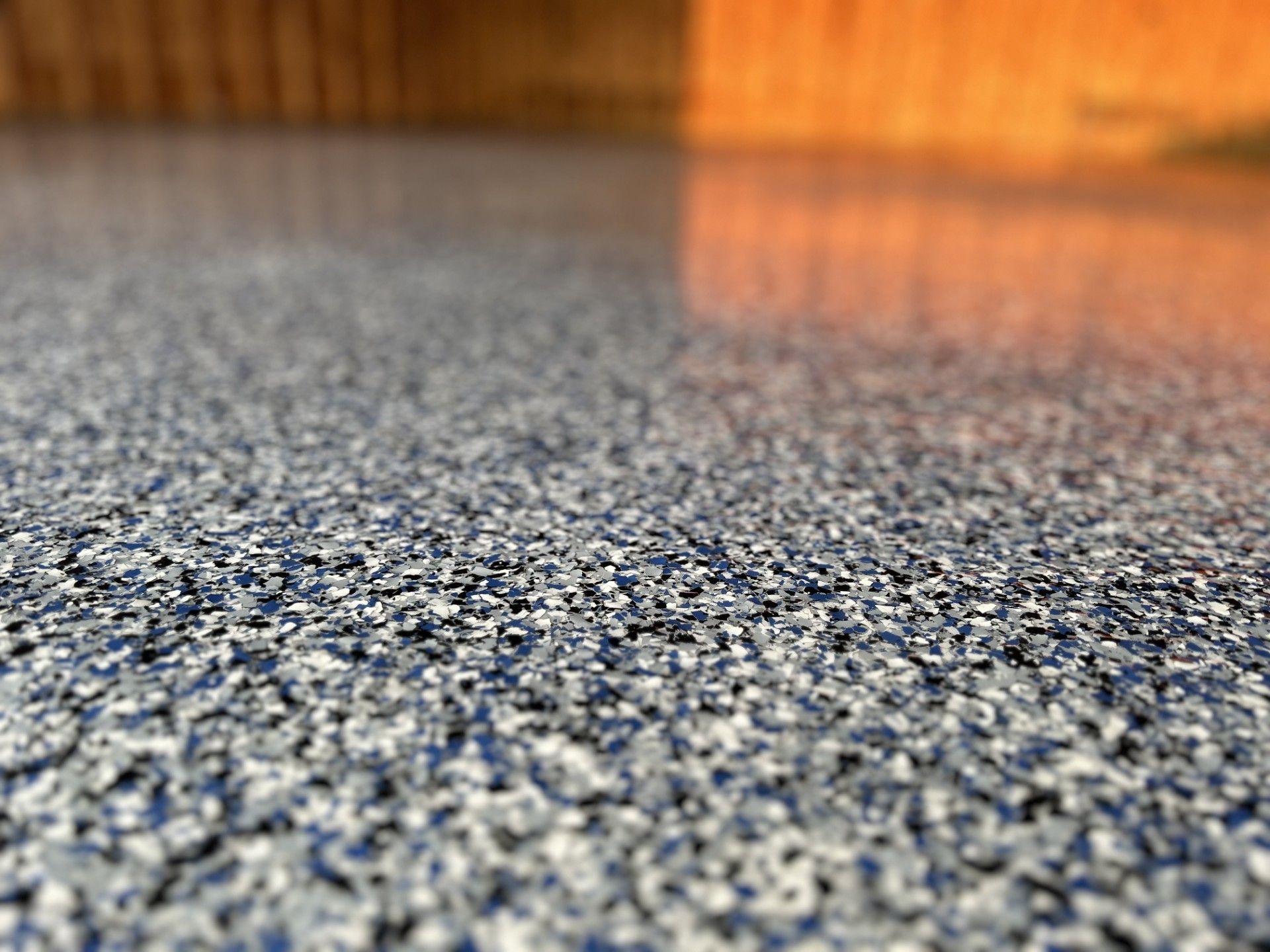 A close up of a concrete floor with a lot of small rocks on it.