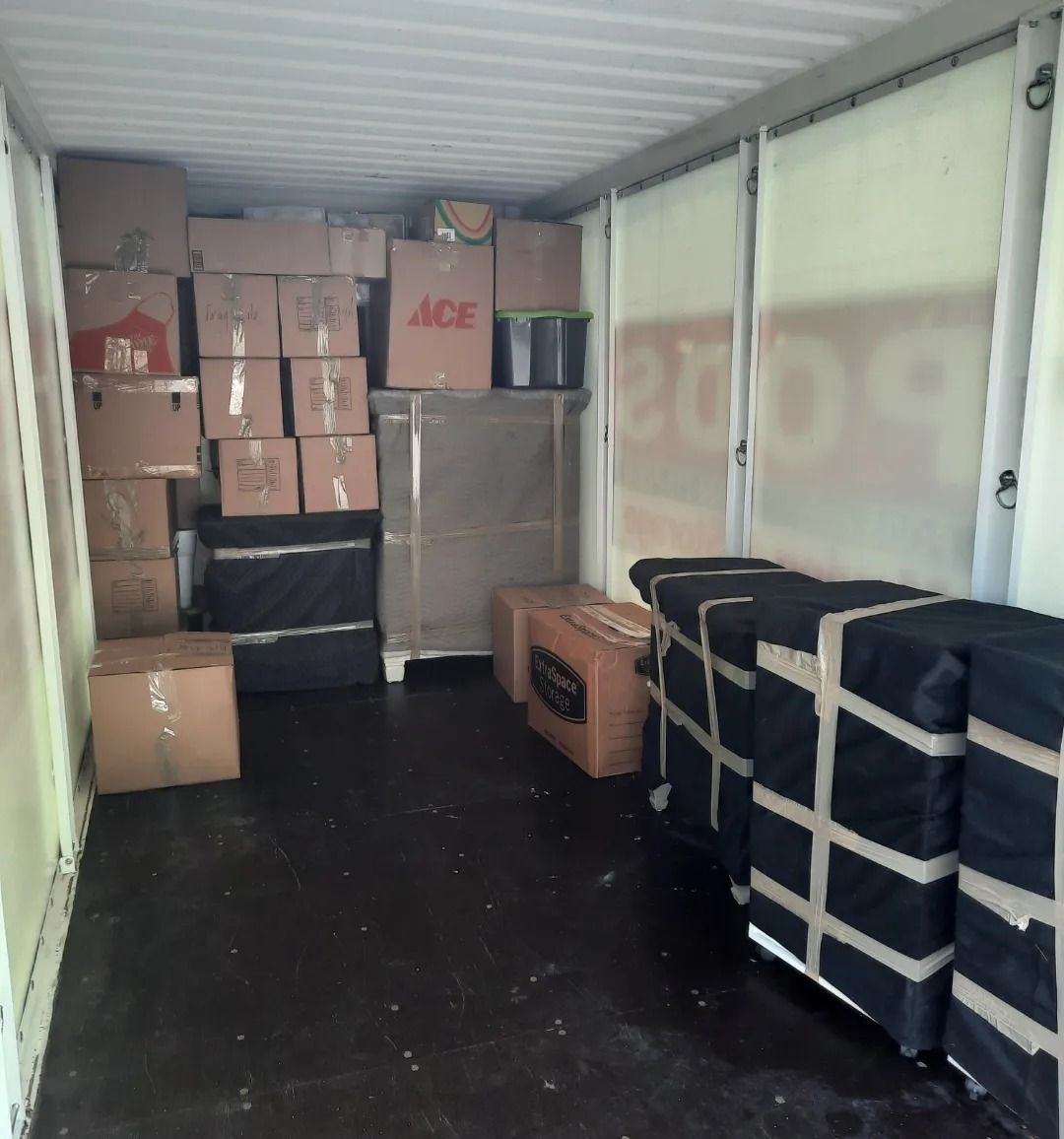 A room filled with boxes including one that says ace