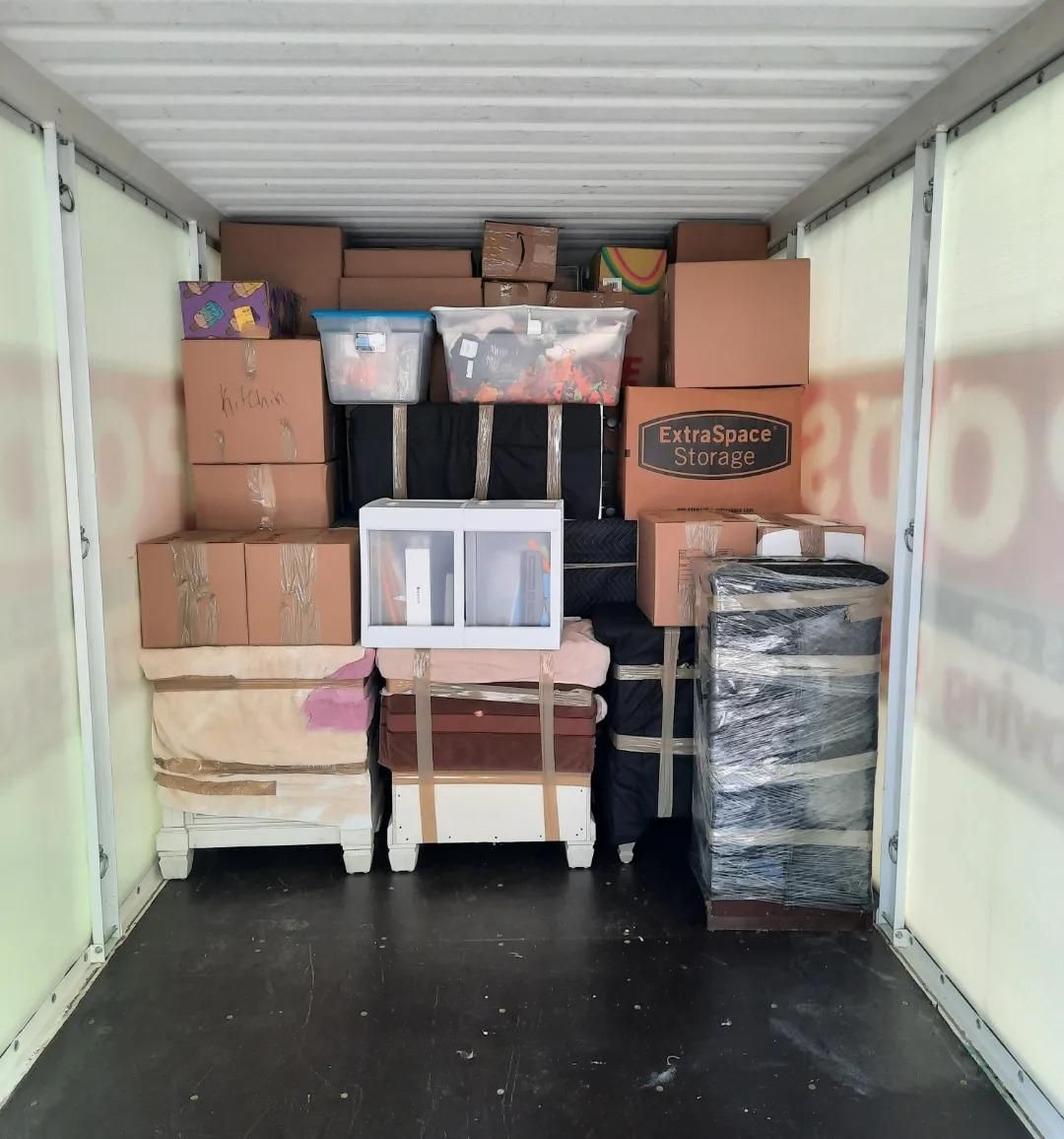 The inside of a moving truck filled with lots of boxes