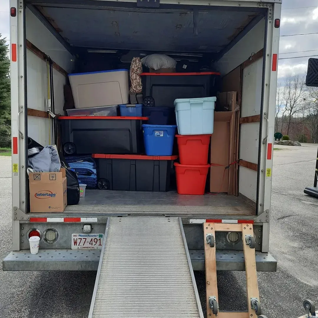 The back of a moving truck filled with boxes and shelves