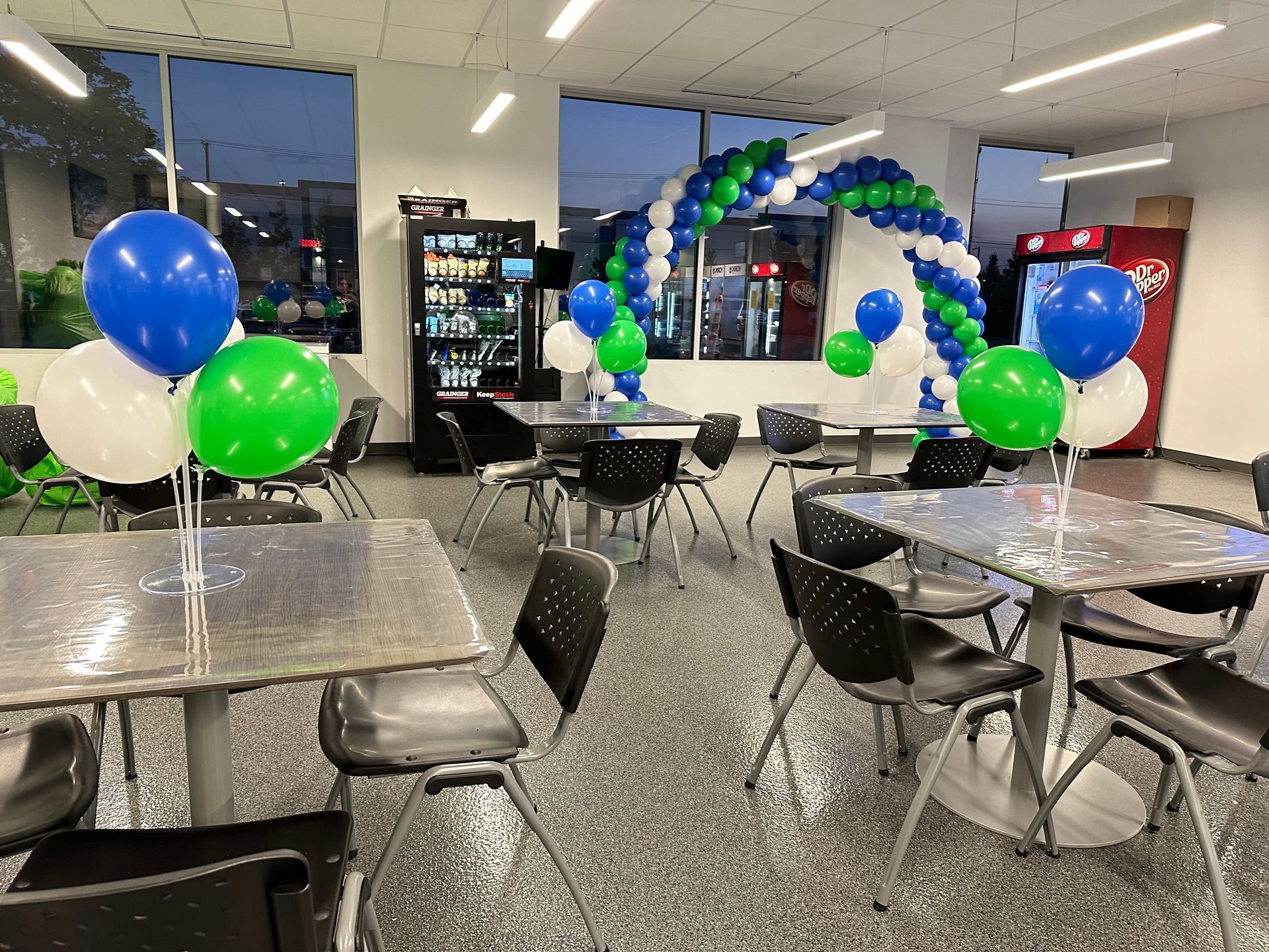 A sign that says bgc is surrounded by balloons and lights.