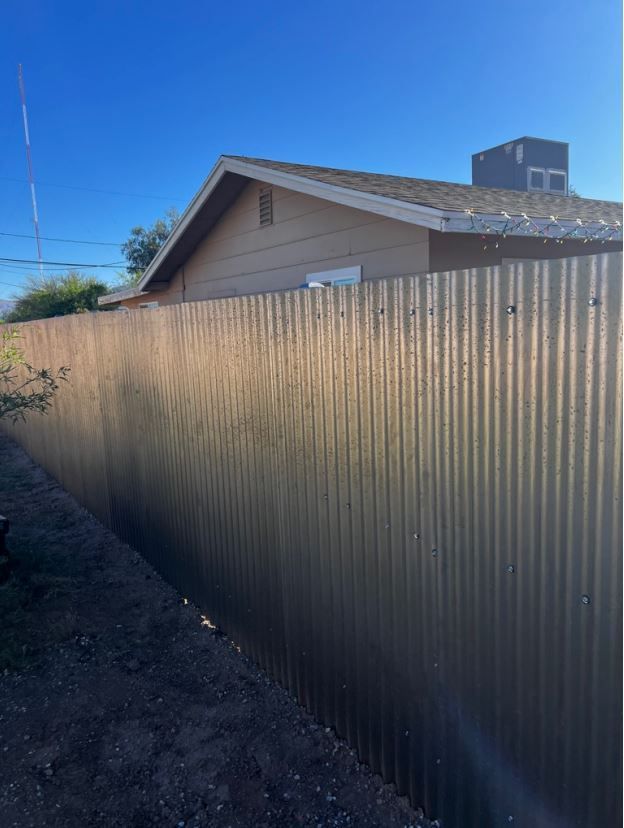 A house with a metal fence in front of it