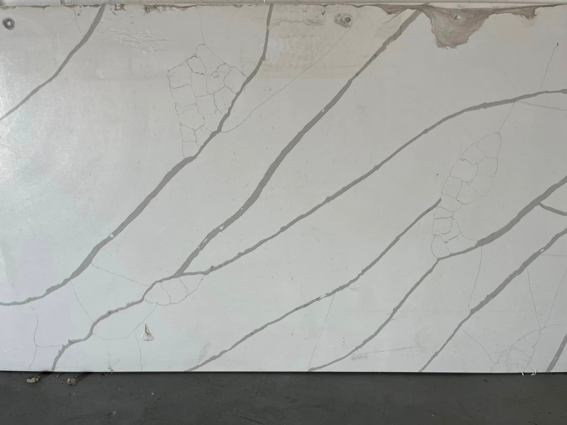 A white tile with a gray stripe on it is sitting on a table.