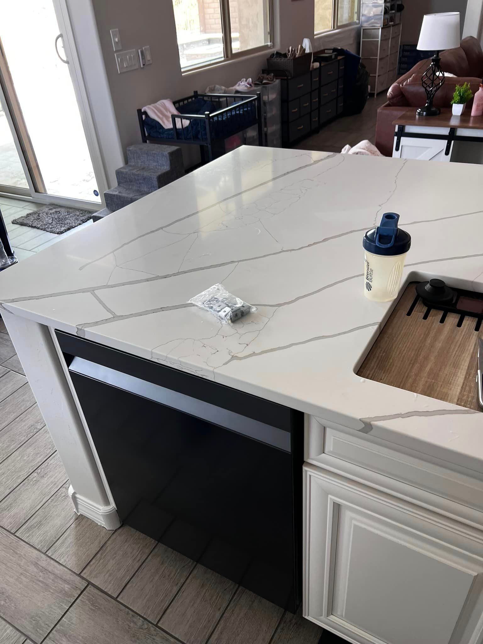 A kitchen with a large island and a sink.