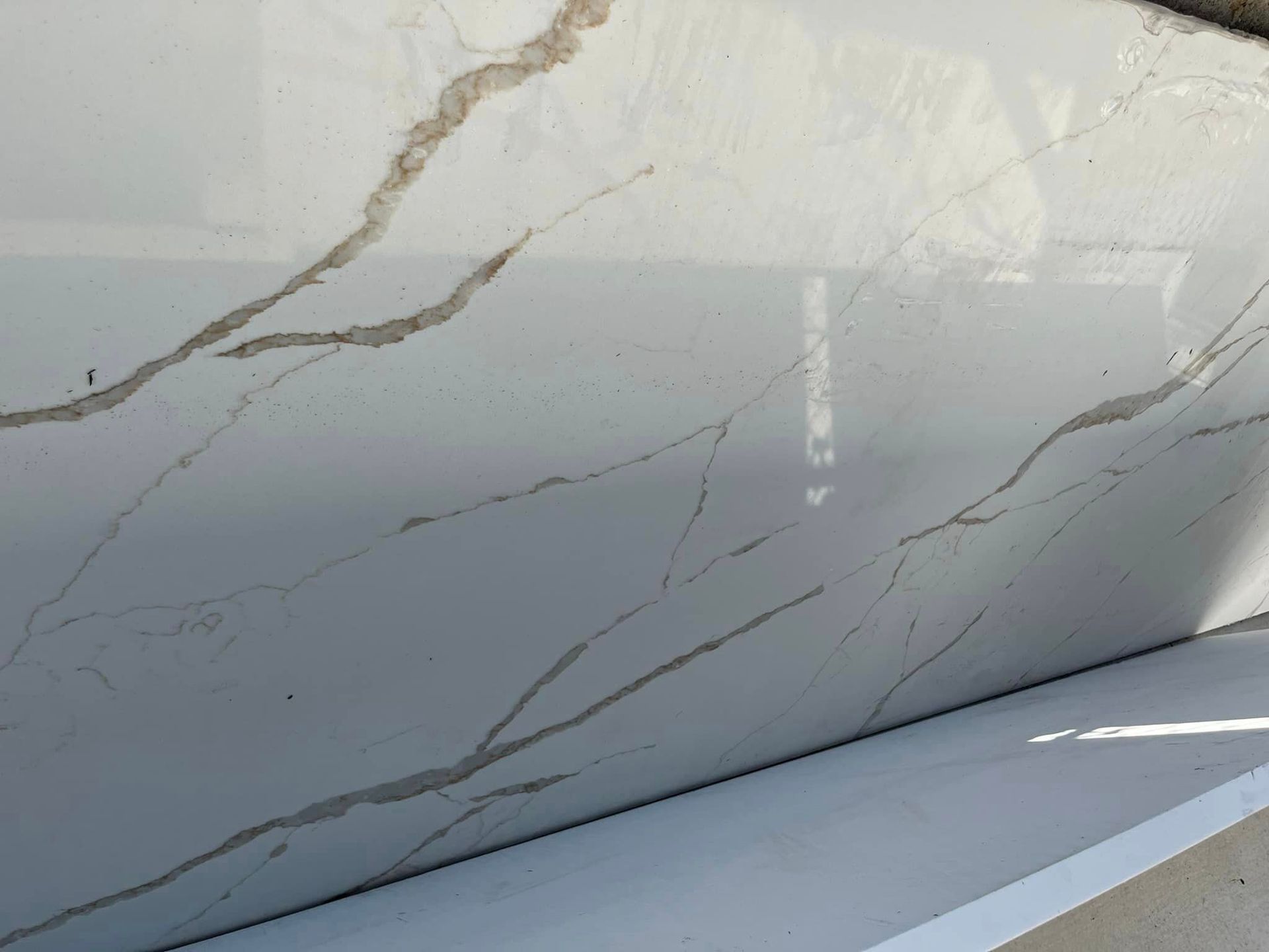 A close up of a white marble counter top.