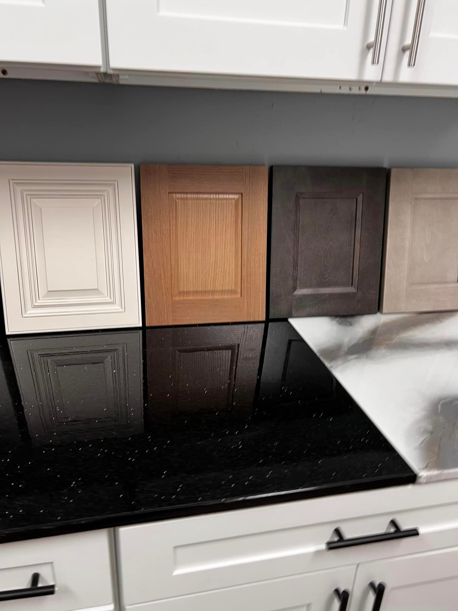 A kitchen counter with different types of cabinet doors on it