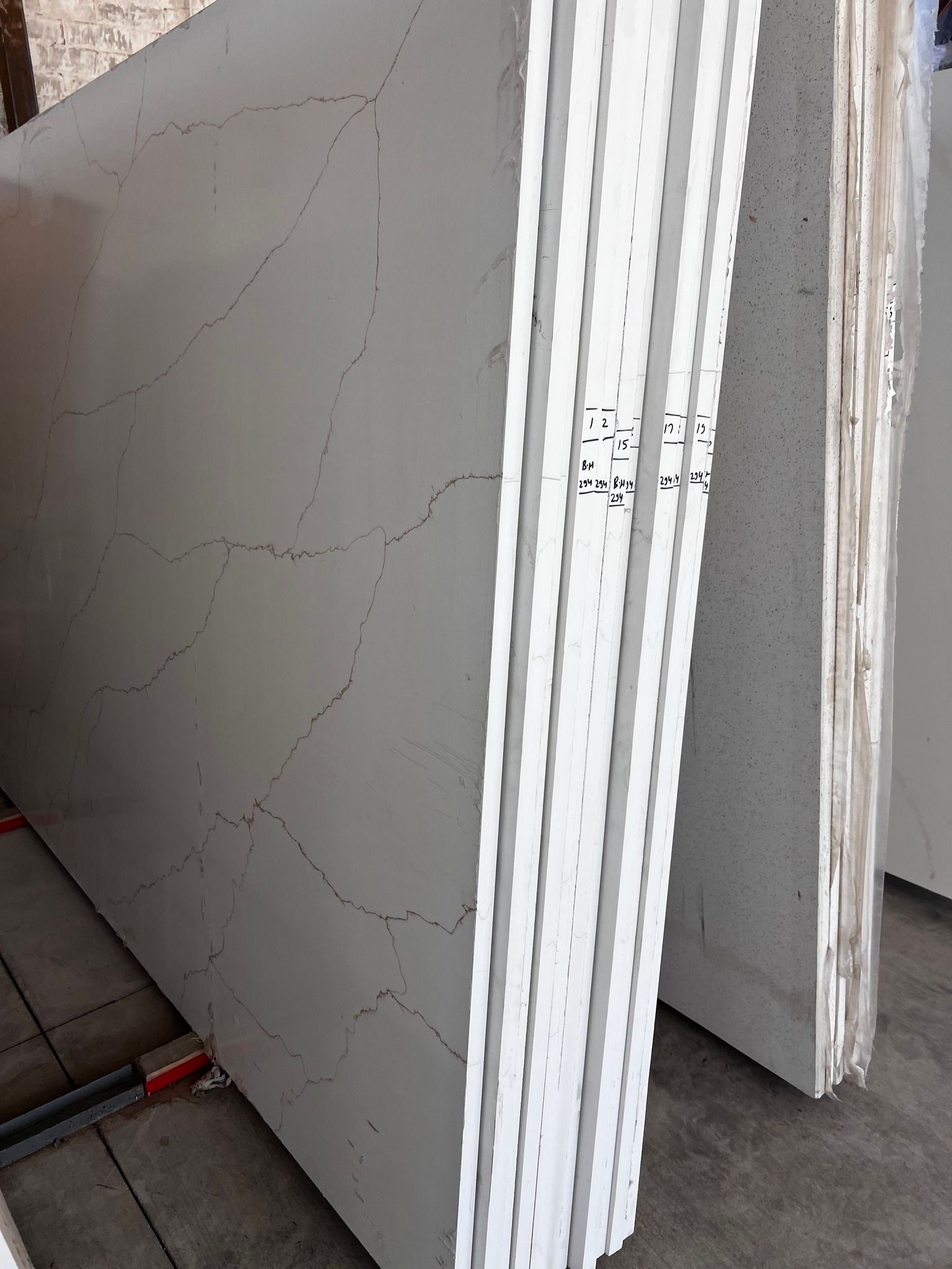 A stack of white granite slabs sitting on top of each other.