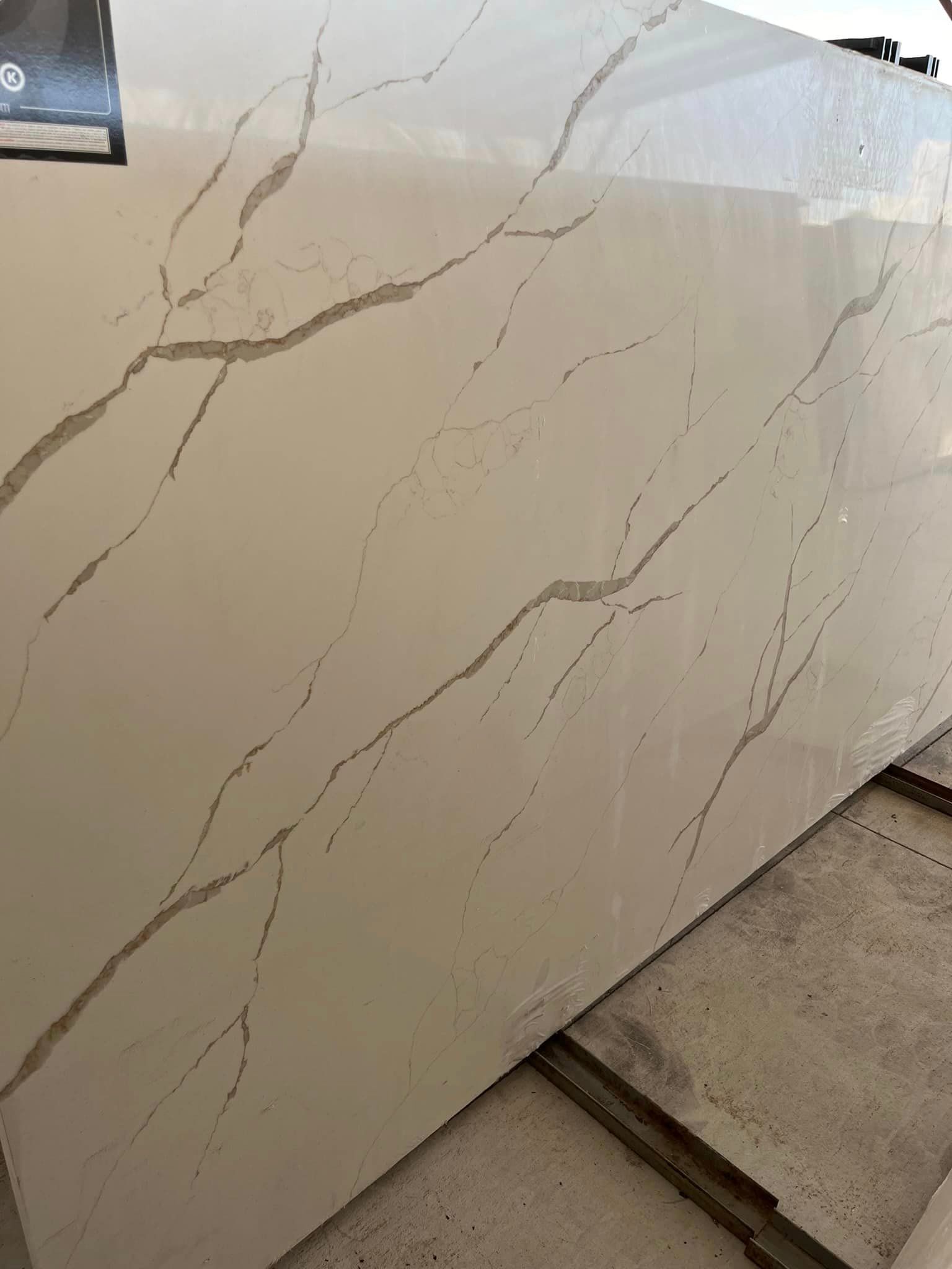 A large white marble slab is sitting on top of a tiled floor.