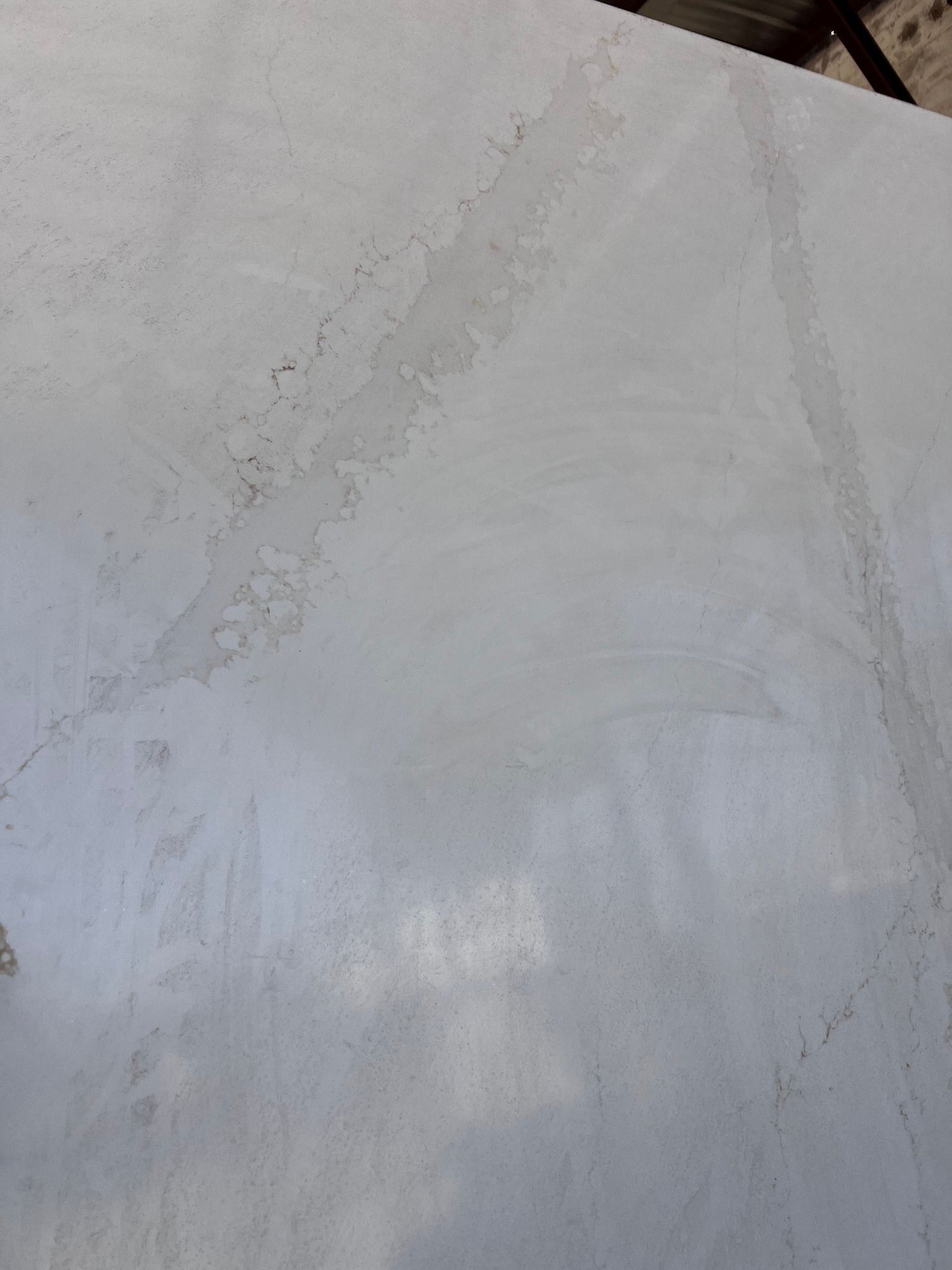 A close up of a white marble counter top.