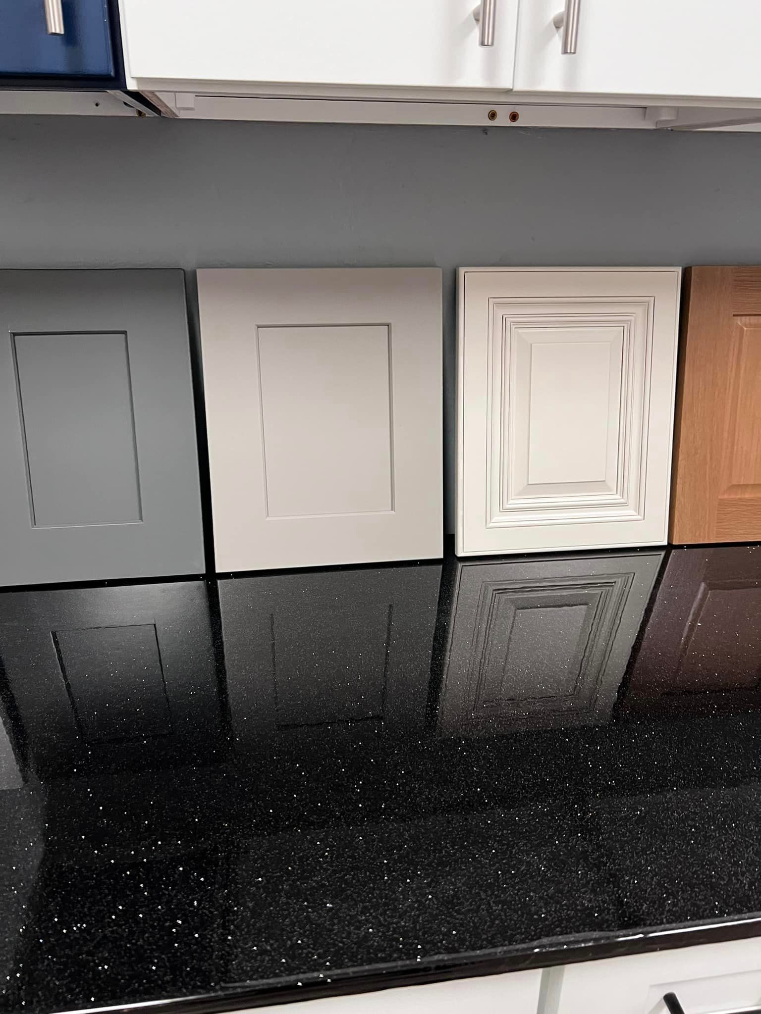 There are many different types of cabinet doors on the counter.