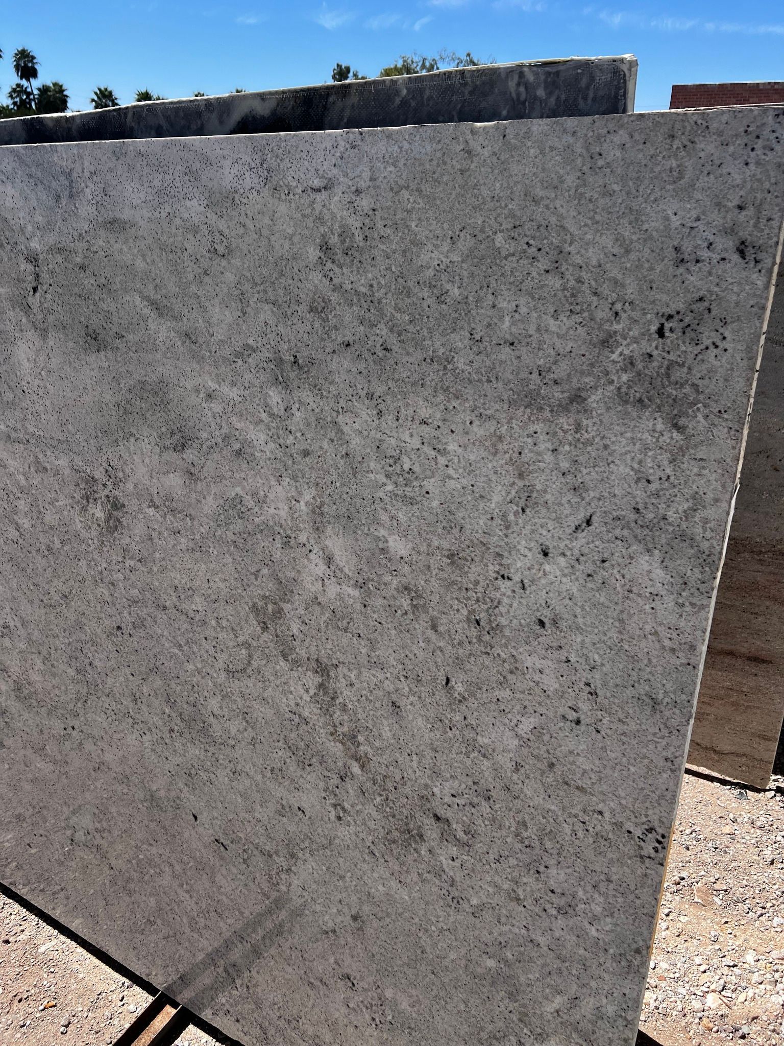 A large gray granite slab is sitting on top of a wooden stand.