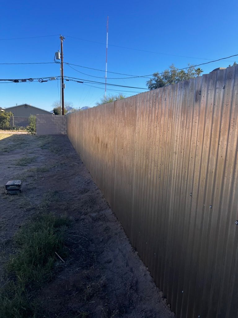 A wooden fence with a blue sky in the background