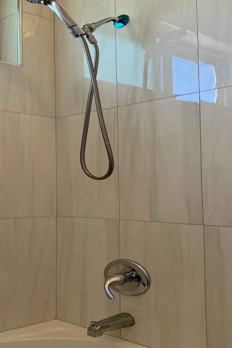 Shower Head is Attached to a Bathroom