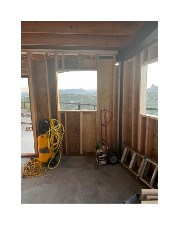 A room under construction with a window and a ladder.