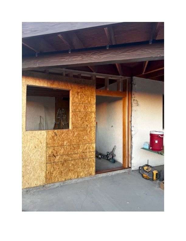 A door is being built into a wall with a window.