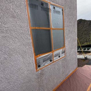 A window is taped to the side of a building.