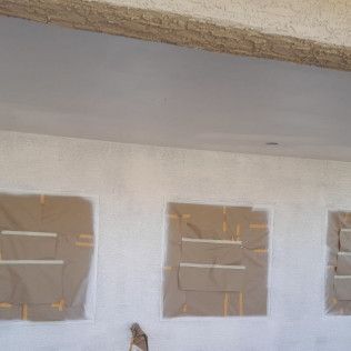 A white wall with a lot of cardboard boxes on it.