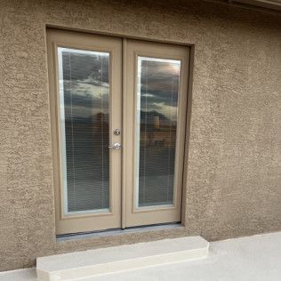 A pair of sliding glass doors on the side of a building.