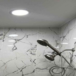 A shower with two shower heads and a light on the ceiling.