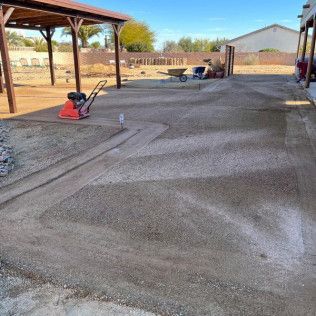 A concrete driveway is being built in front of a house.