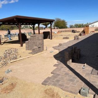 A patio is being built in the desert with a gazebo in the background.