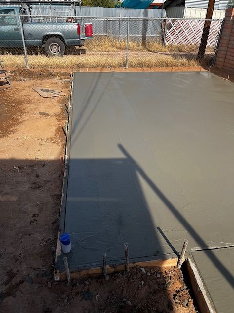 A truck is parked next to a concrete slab