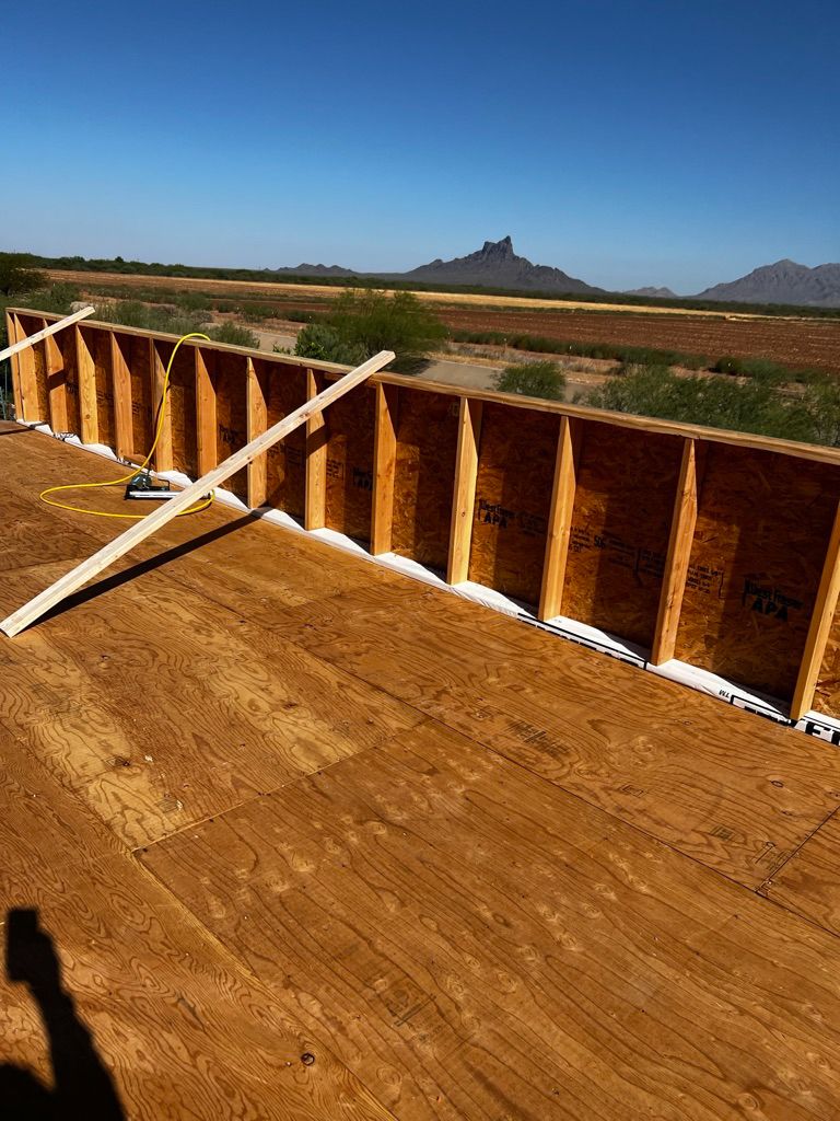 A wooden wall is being built on top of a wooden floor.
