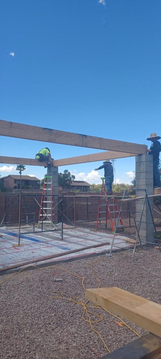 A group of construction workers are working on a building.