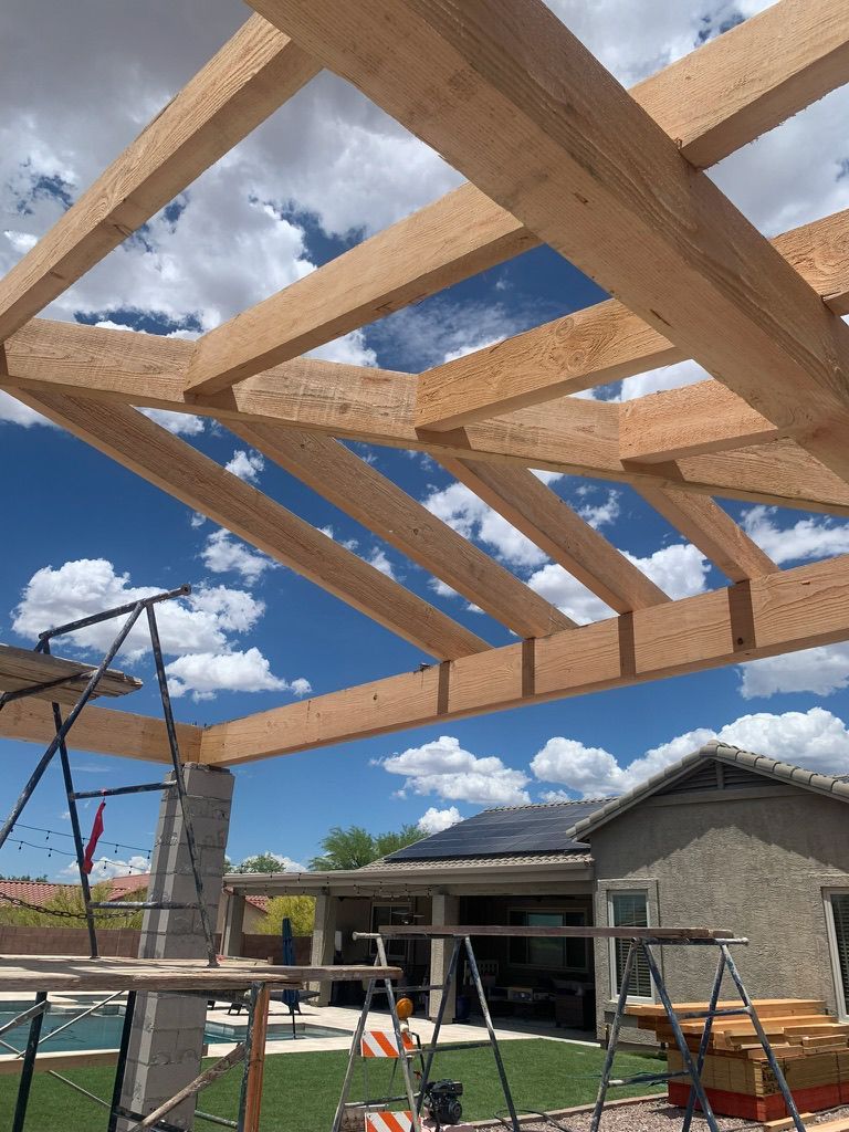 A wooden structure is being built in front of a house.