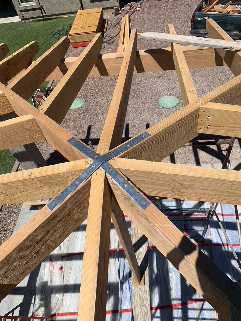 A wooden structure is being built on top of a concrete floor.