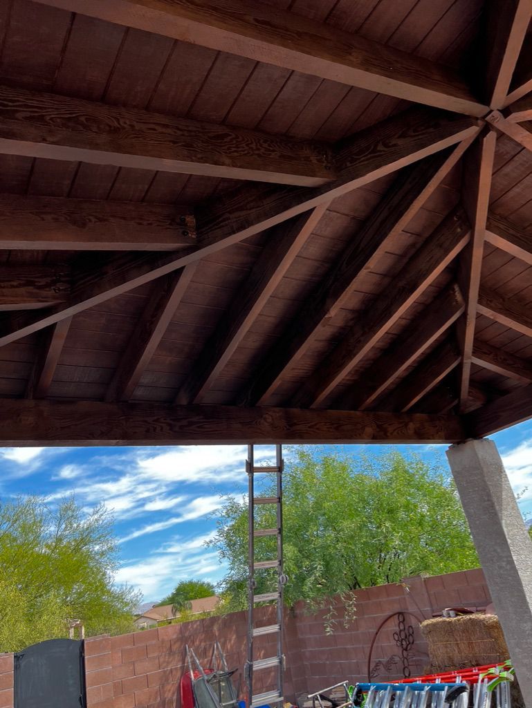A ladder is hanging from the ceiling of a wooden structure.