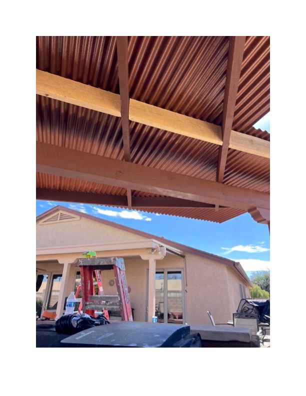 A house with a wooden roof and a ladder in front of it.