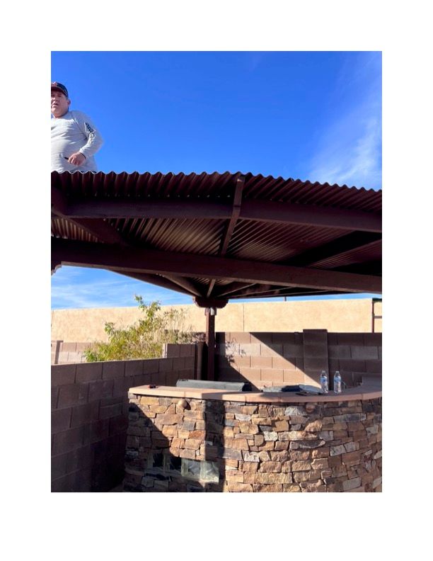 A man is standing on top of a metal roof.