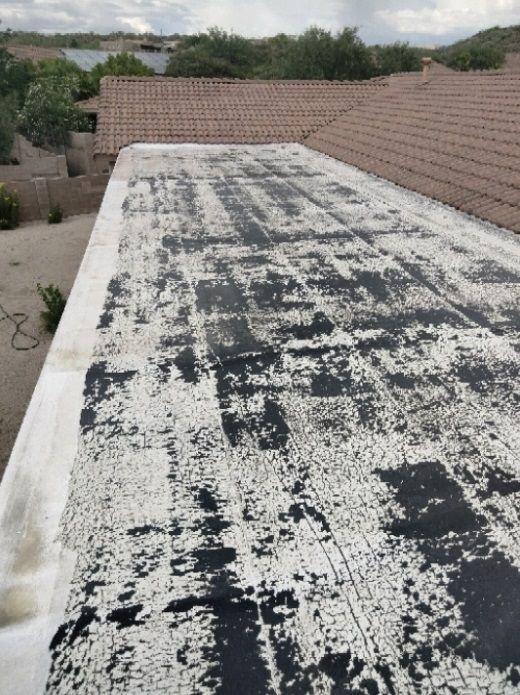 A roof with a lot of black and white spots on it