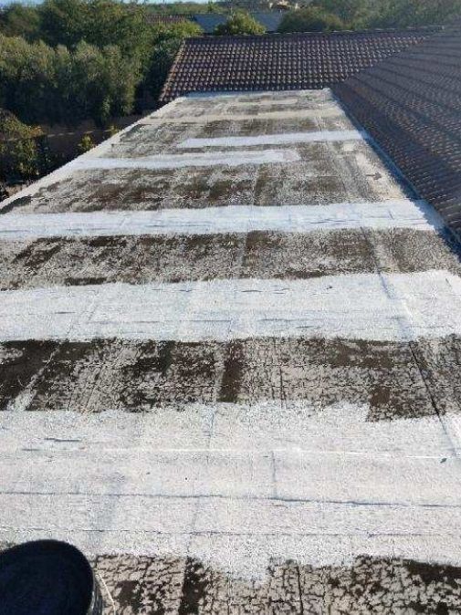 A person is standing on the roof of a building.
