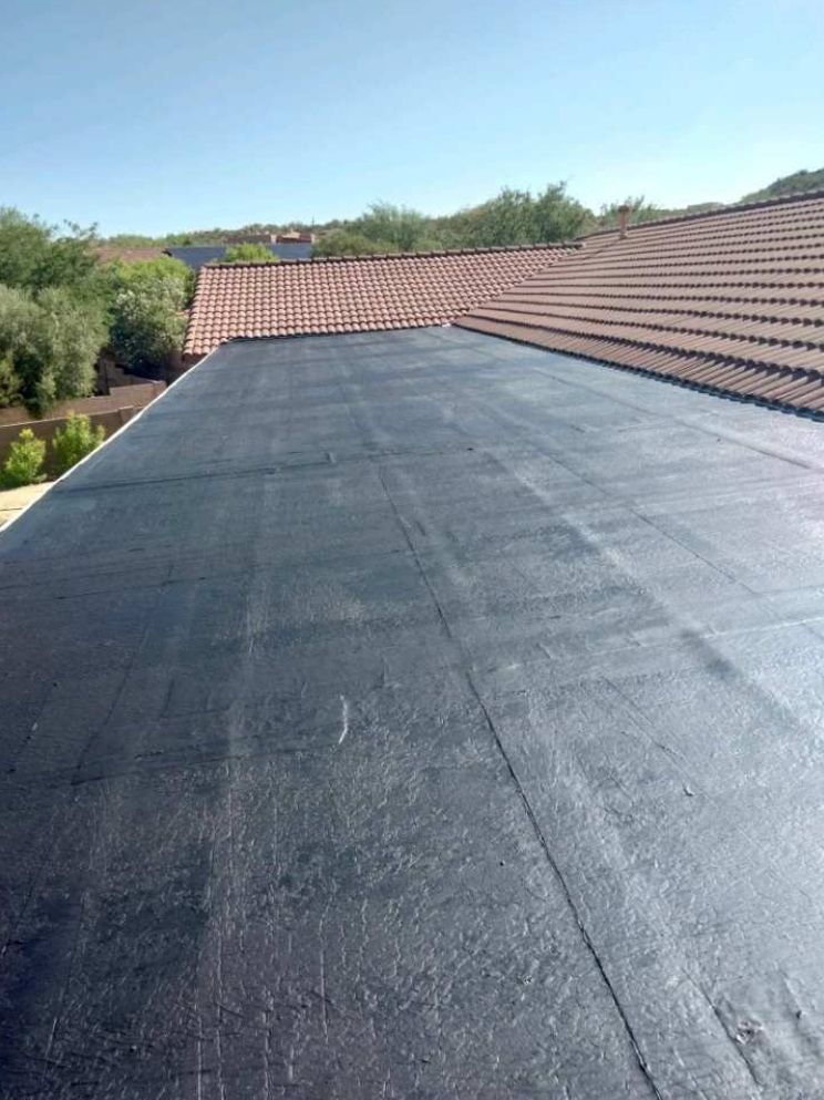 A roof with a black roof and a solar panel on it.
