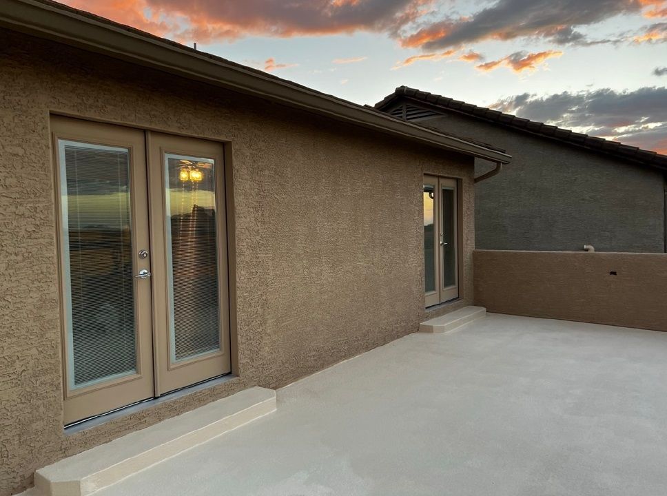A house with a patio and sliding glass doors