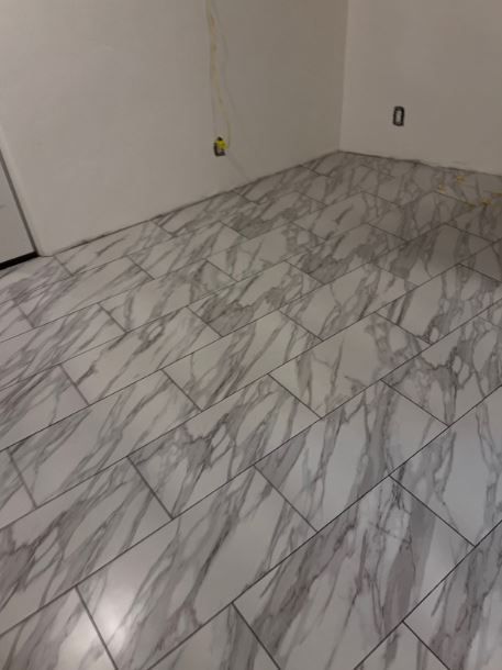 A room with a marble floor and white walls.