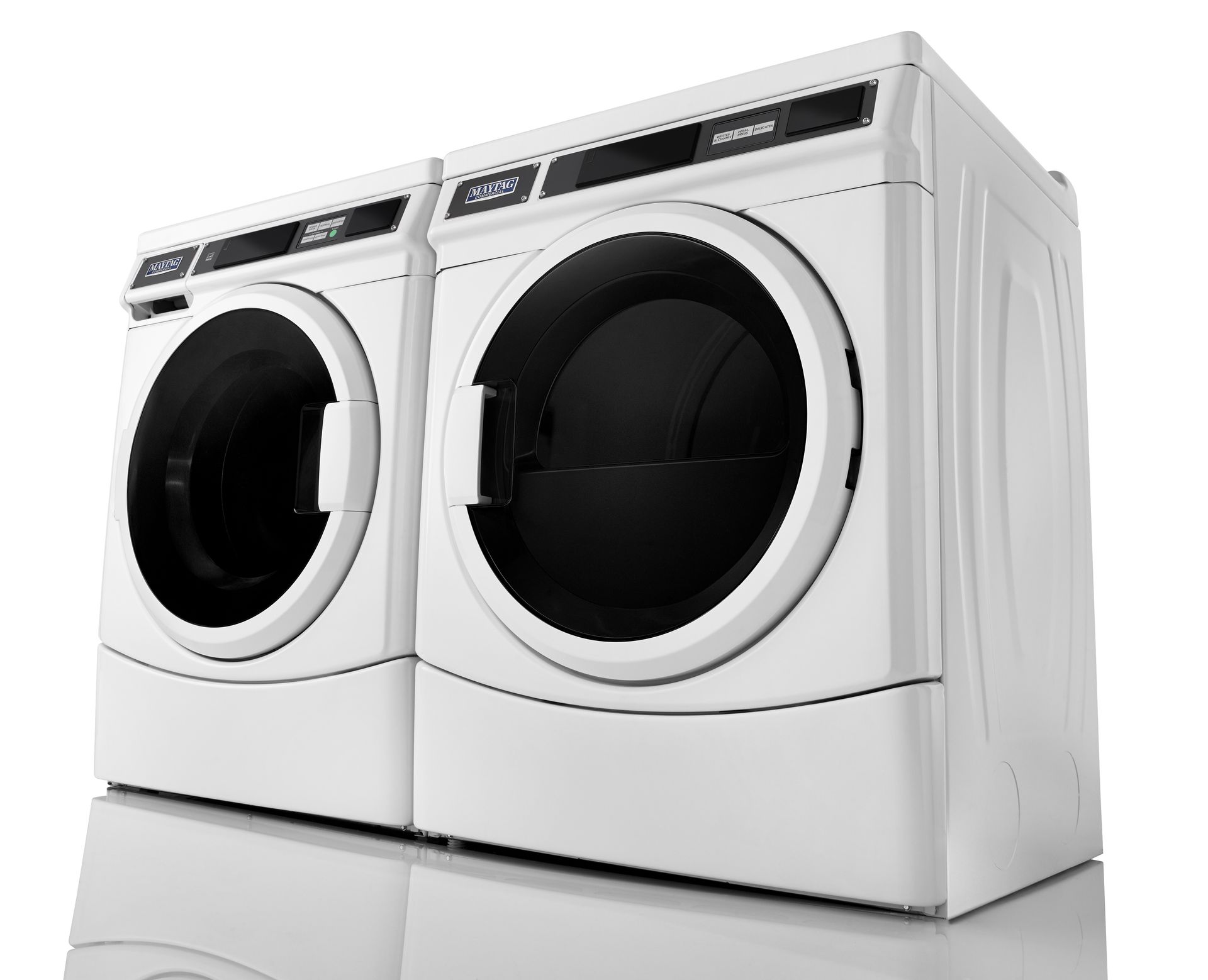 A washer and dryer are stacked on top of each other on a white surface.