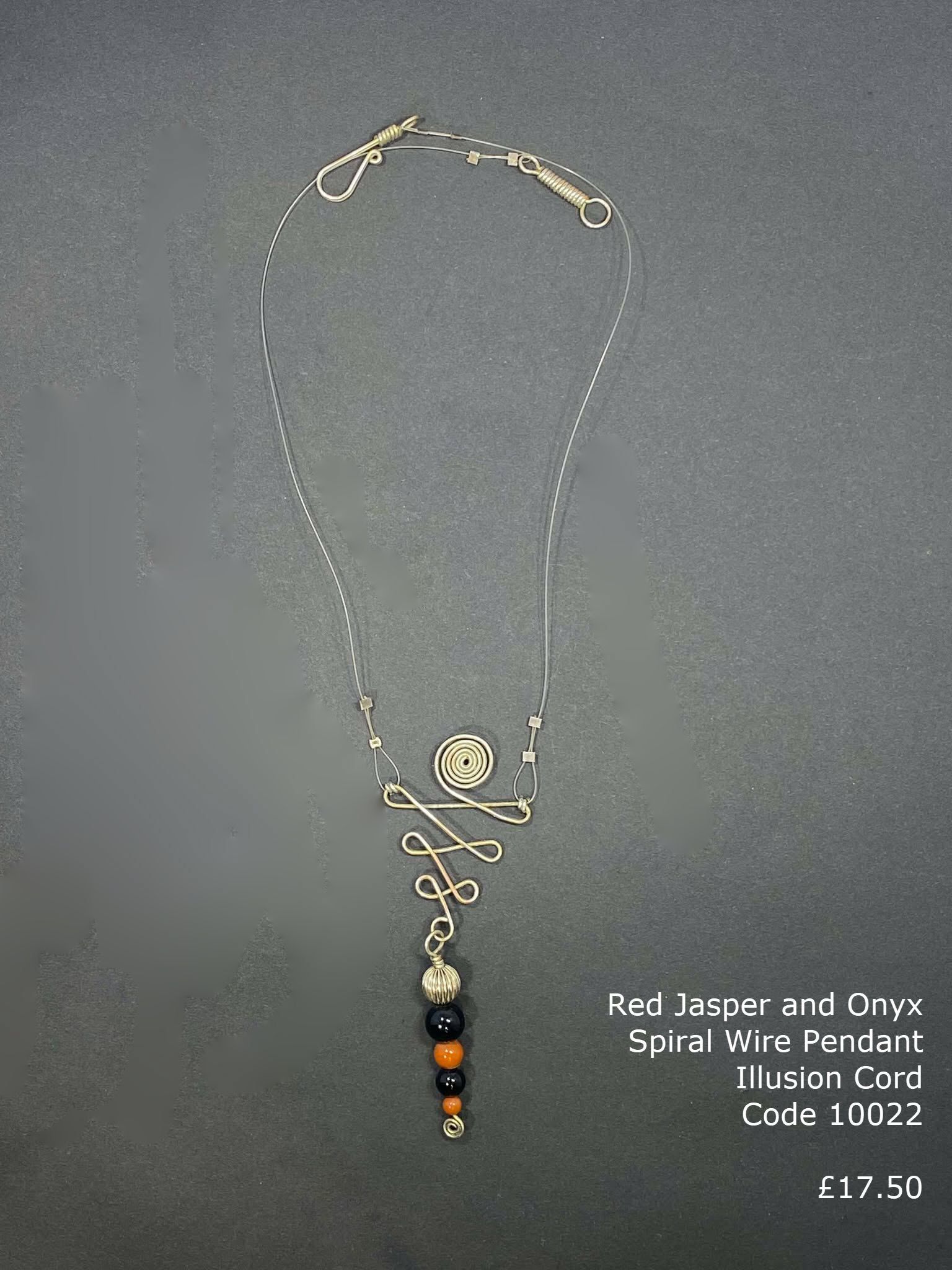 Red Jasper and Onyx in spiral wire design on illusion cord.