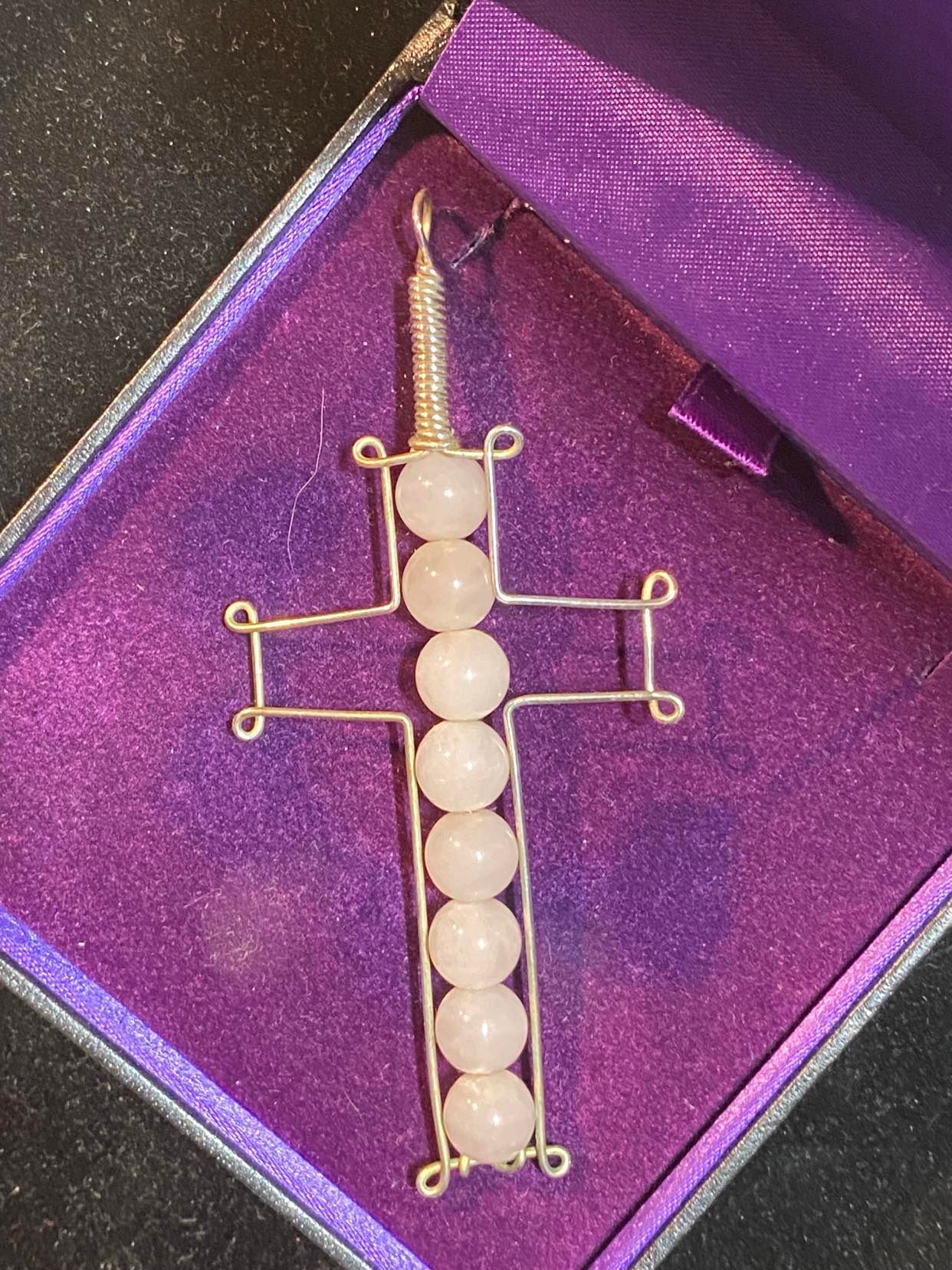 Wire cross with Rose Quartz beads.